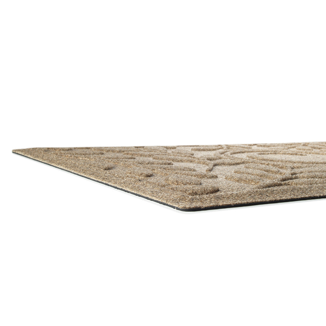 Side profile photo of WaterHog monogrammed Brittney leaf low-profile doormat to fit under nearly any door, made with recycled materials and durable rubber backing.