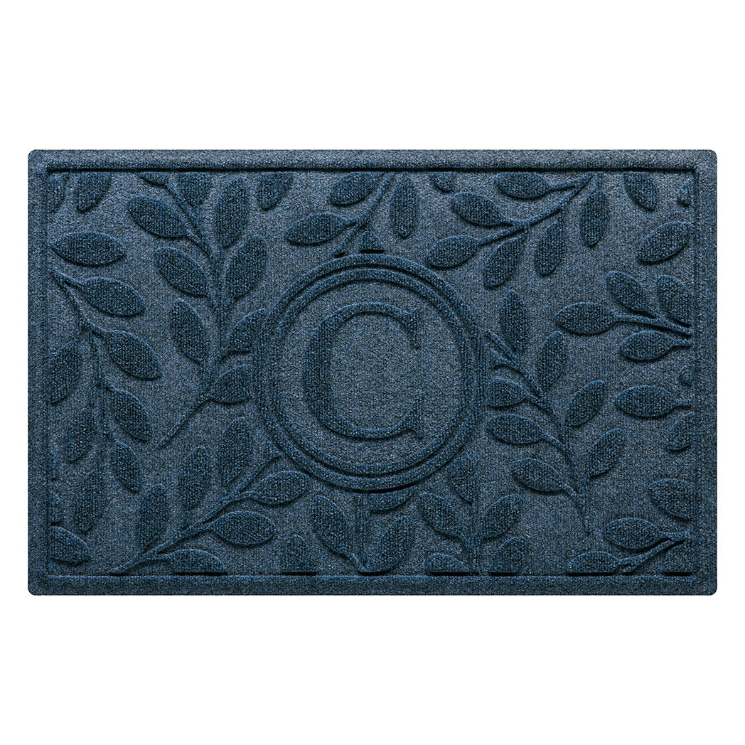 Deep blue genuine WaterHog doormat monogrammed with a letter in the center surrounded by a botanical leaf bi-level design perfect for scraping shoes and trapping moisture, dirt, and debris.