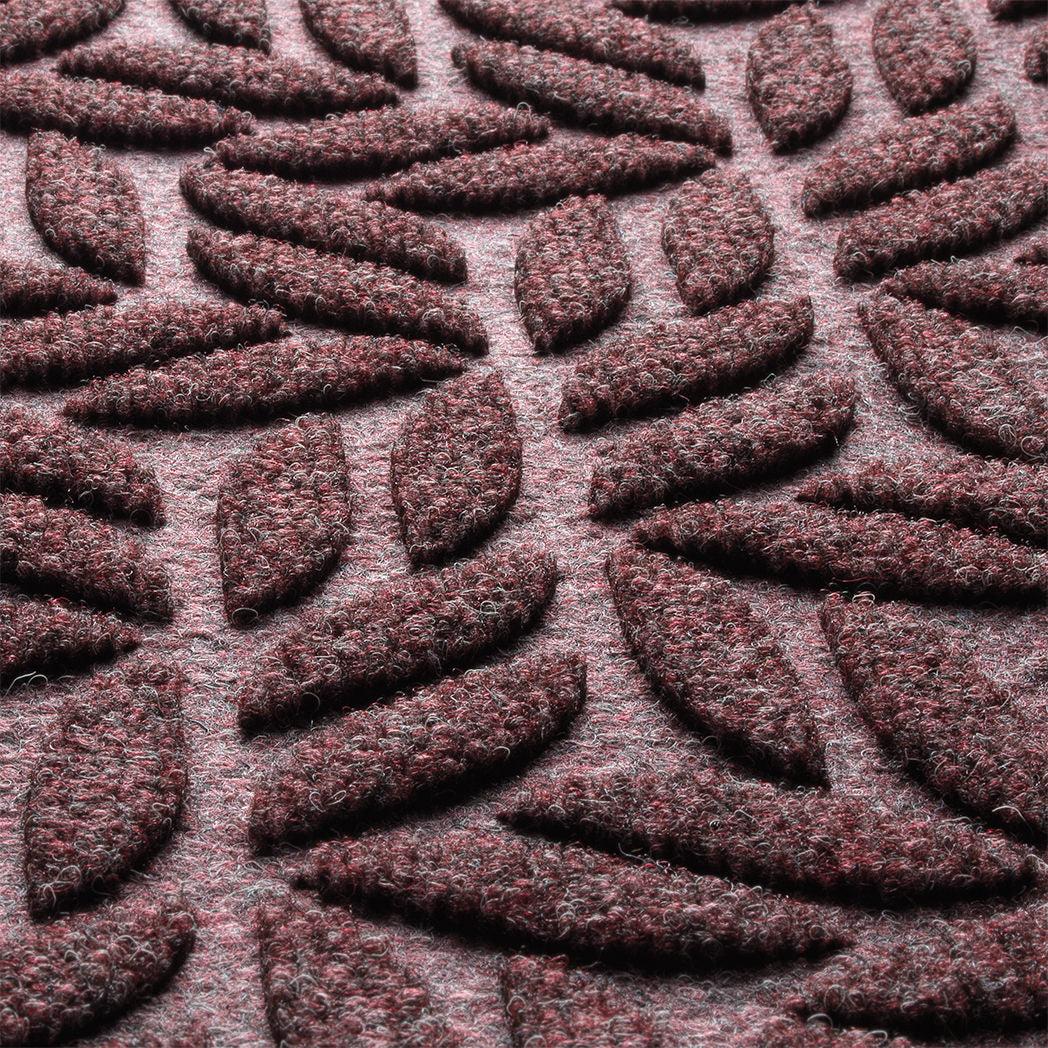 Close-up of WaterHog fibers made of deep wine red, white, and grey fibers pressed to make an aesthetic design.