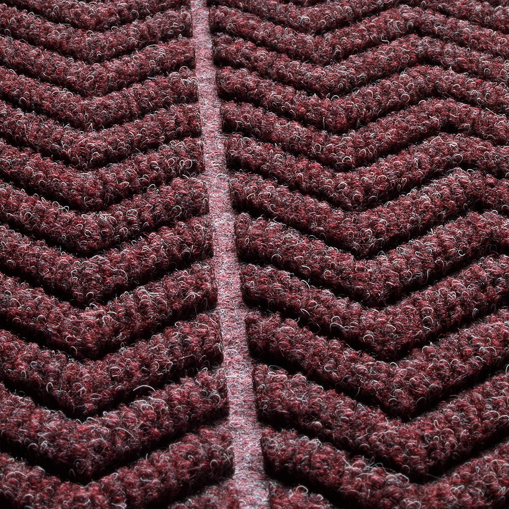 detailed photo of WaterHog chevron surface focusing on the bi-level design and PET fibers in colors red, black, and grey.