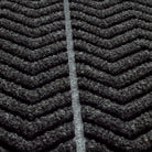 Zoomed in view of WaterHog Chevron doormat's surface detailing the bi-level recycled PET surface in fiber colors black and grey.
