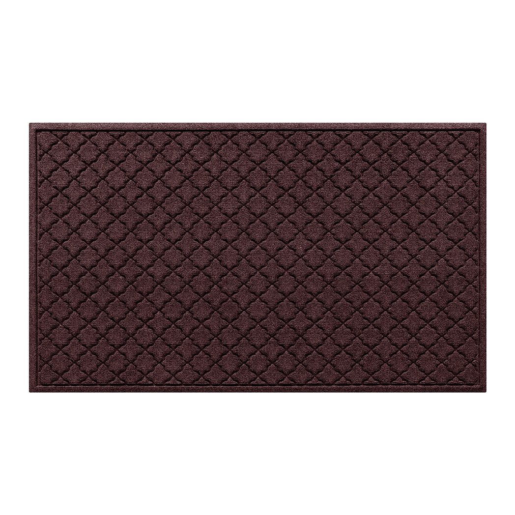Overhead of a large Cordova all-weather door mat with a deep wine red repeating quatrefoil, bi-level design.