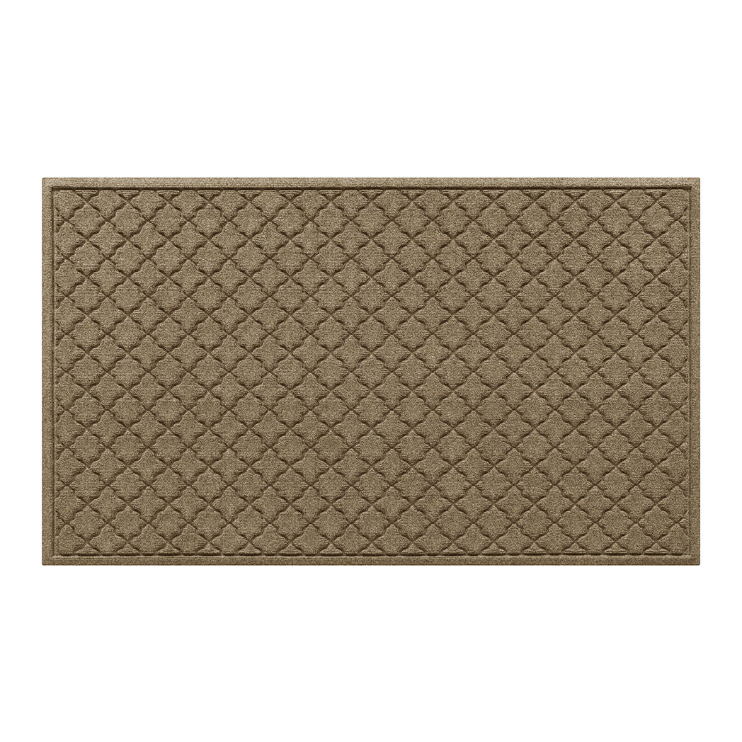 Overhead of a large WaterHog indoor/outdoor doormat in a light tan, repeating quatrefoil design; an American-made mat.