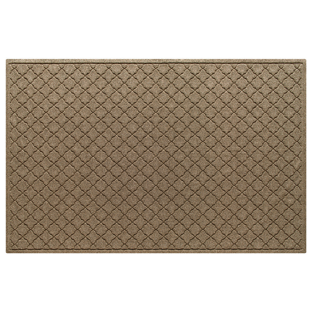 An OG WaterHog 4x6 indoor/outdoor doormat in a light tan repeating quatrefoil, bi-level design.