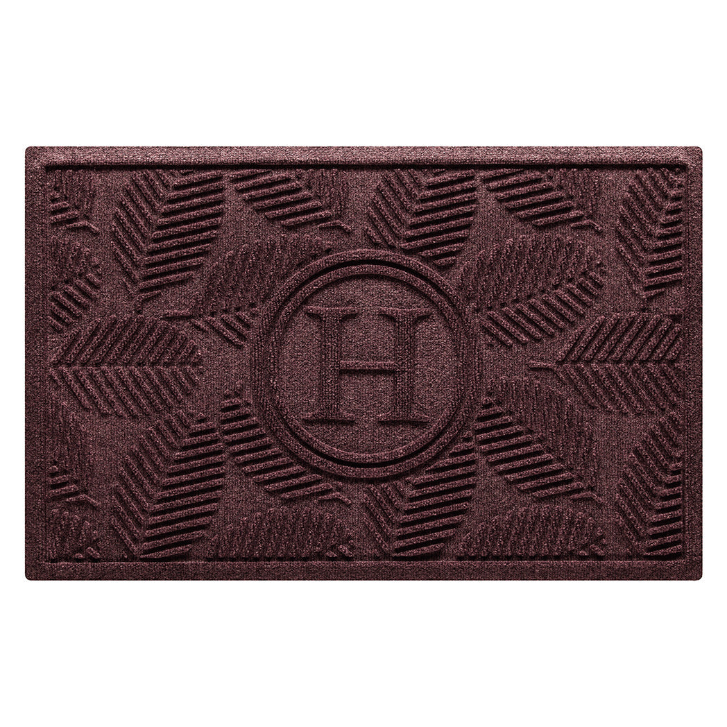 WaterHog 2x3 Deanna, all-weather monogram doormat with a deep wine red leafy design, on a water-resistant surface.