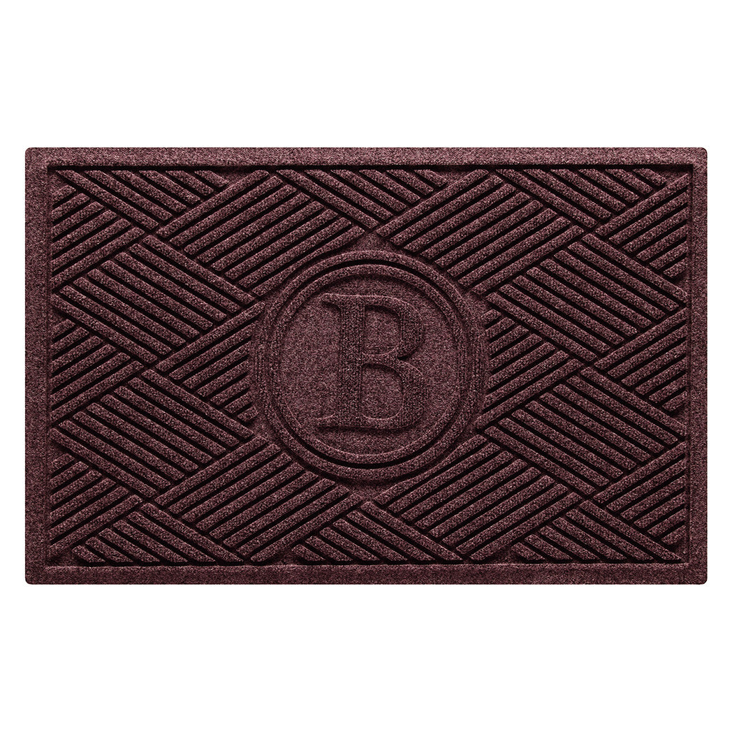 A monogrammed WaterHog all-weather doormat with a deep wine-red surface and crisscrossing linear pattern.