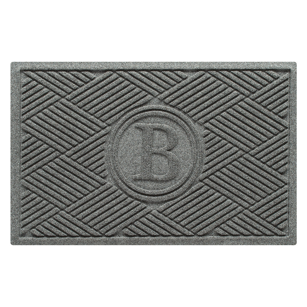 Overhead of a WaterHog Boxwood doormat in a light grey surface and crisscrossing linear pattern.