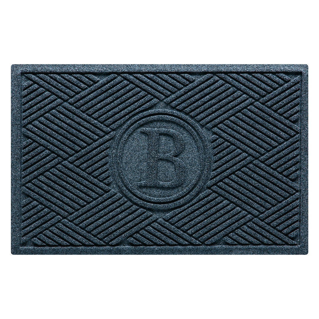 Overhead of a monogrammed Diamonds doormat with a relaxed blue crisscrossing linear and eco-friendly, durable surface.