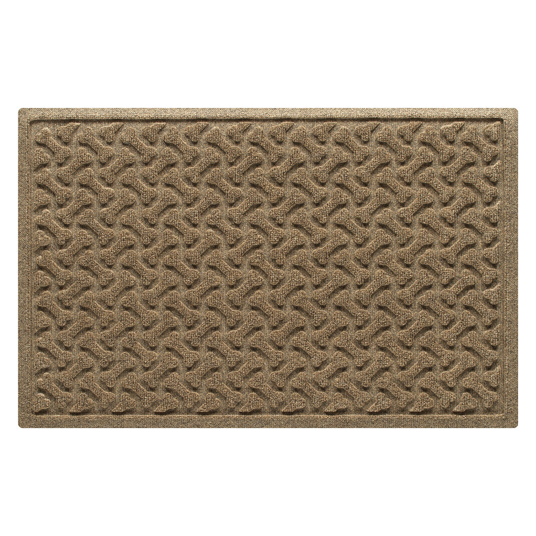 Overhead of a medium Dog Bones WaterHog indoor/outdoor doormat with a light tan color and surface and durable rubber backing.