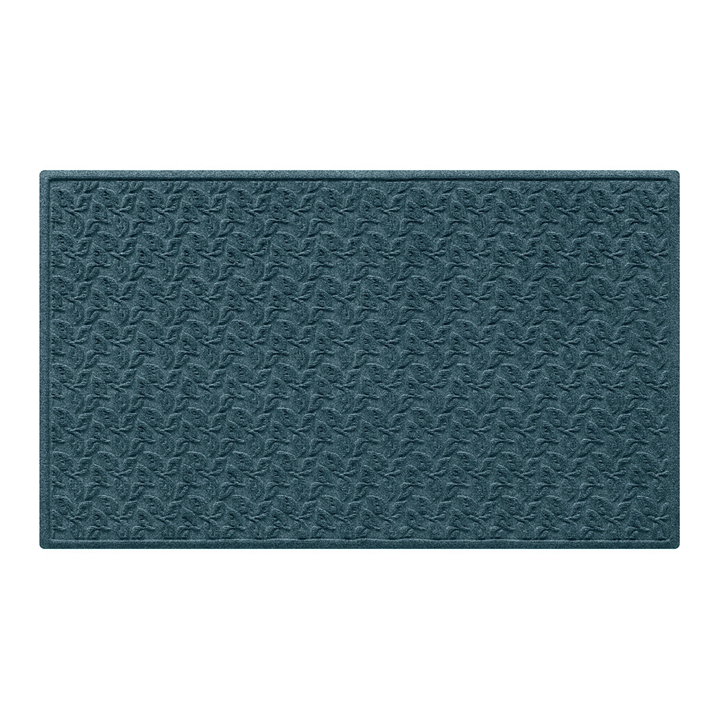 large doormat in a creamy warm blue with a repetitive dogwood leaf pattern backed by durable rubber