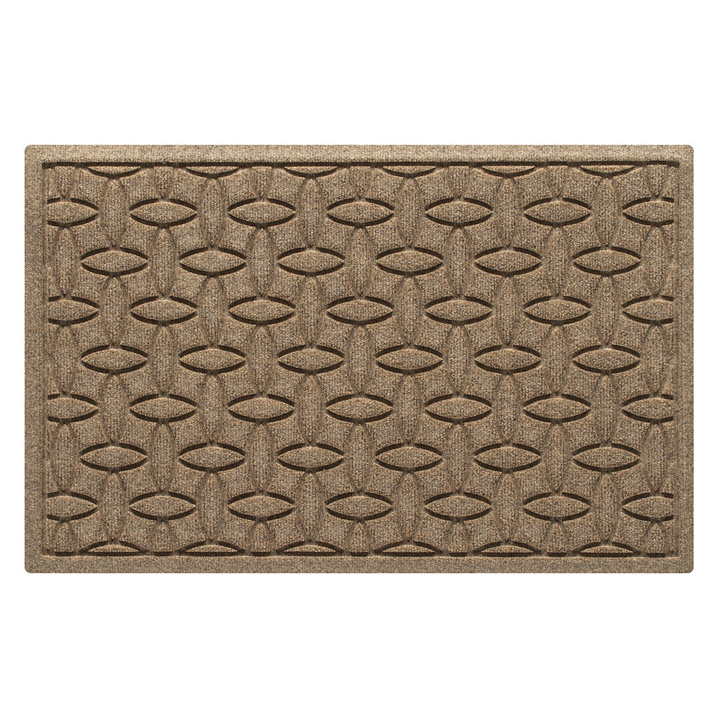 The OG WaterHog medium indoor/outdoor doormat in a light tan color and interlocking elliptical, bi-level design.