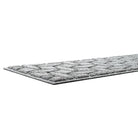 A close-up of WaterHog Ellipse's low-profile overall height, and durable rubber backing in the color light grey.