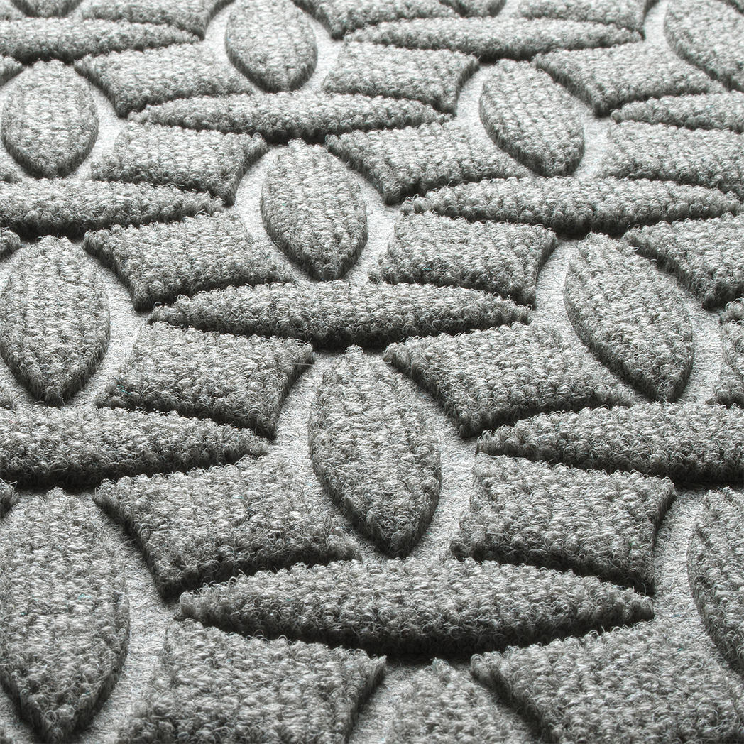 Detail shot of the fade-resistant WaterHog Ellipse surface creating a light grey, durable long-lasting doormat.