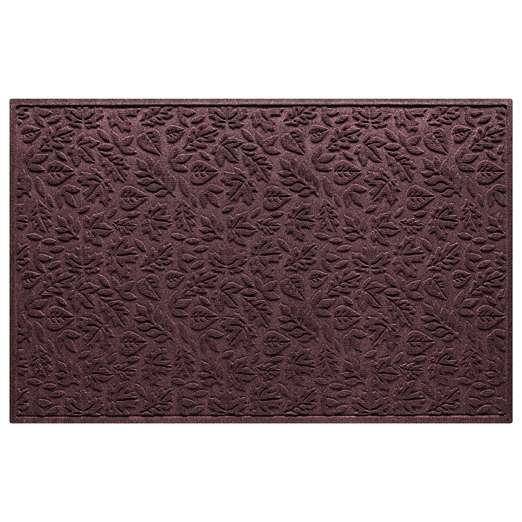 Overhead shot of a WaterHog door mat in a burgundy color with a fallen leaf pattern.