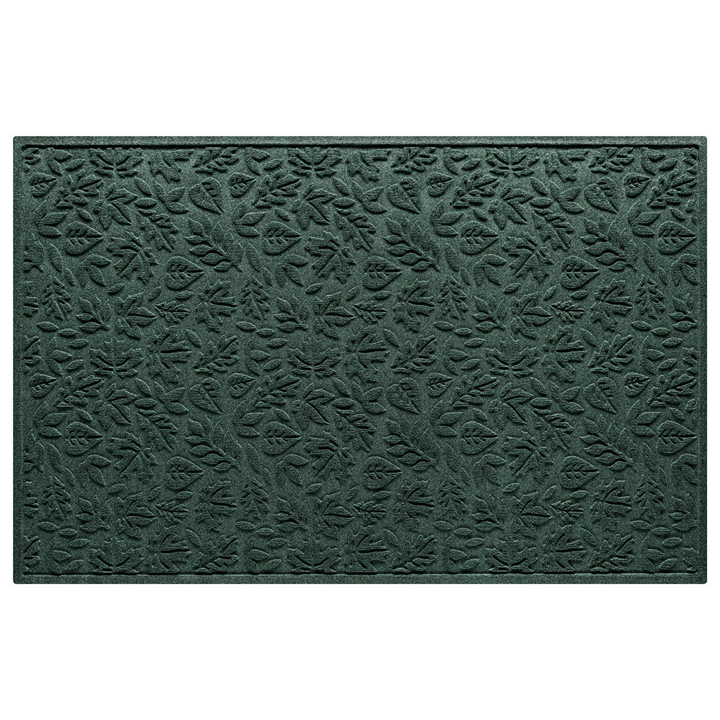 An extra large WaterHog premium door mat with a deep green fallen leaves pattern.