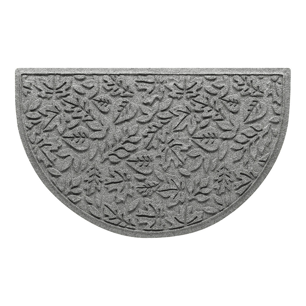 Overhead of a WaterHog Fall Day doormat in a light grey surface and fallen leaves pattern.