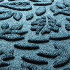 Detail image the all-weather WaterHog durable surface made of dark and light blues, white and grey strands.