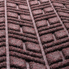 Detail shot of the all-weather WaterHog fibers made of deep wine red, white, and grey fibers pressed to make an aesthetic design.