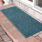 Blue textured doormat runner with snowflake pattern on a brick patio