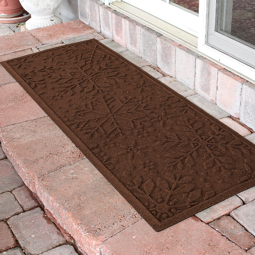 Brown outdoor runner doormat with a textured pattern on a stone patio