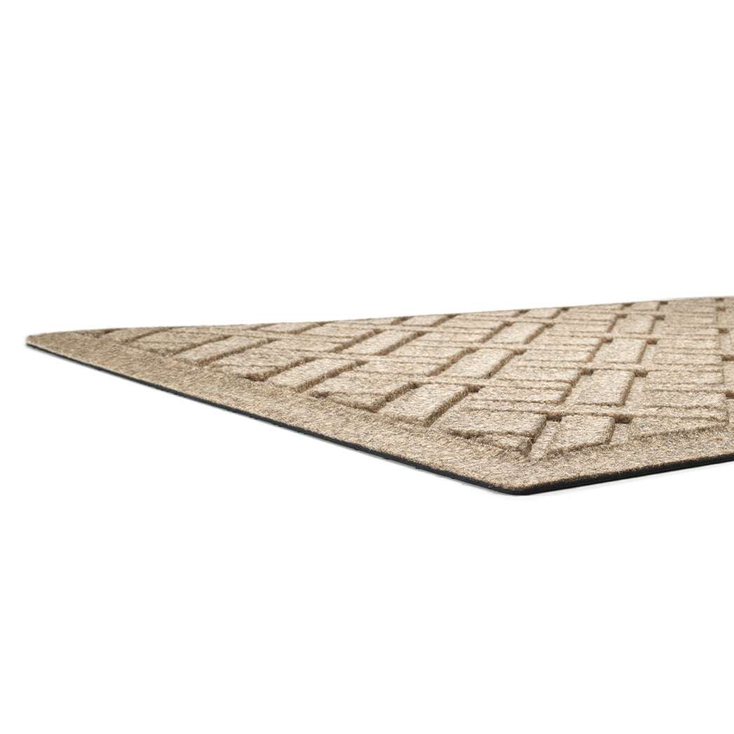 A low and close shot of WaterHog Lattice doormat's no snag, low-profile and durable rubber backing.
