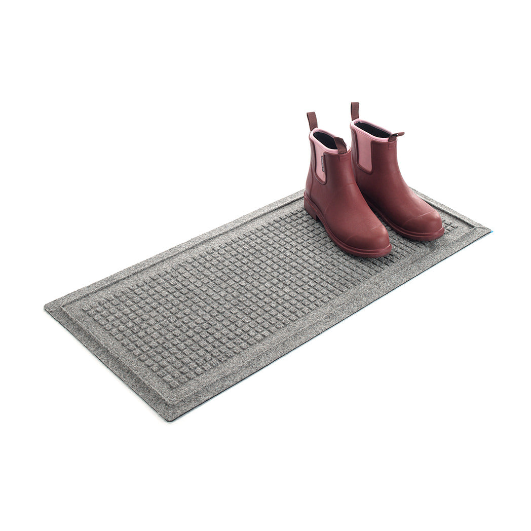 A luxury WaterHog Squares boot tray mat in light grey with a set of clean boots resting on top  on a white background.