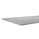 A low and close shot of grey WaterHog Squares doormat no snag, low-profile mat with an eco-friendly PET surface and durable rubber backing.