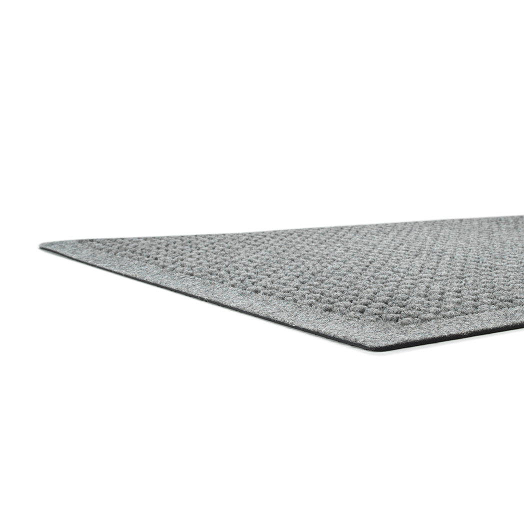 A low and close shot of Square's low-profile edge, bi-level surface, and rubber backing, all on a white background.