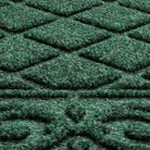 A close-up of Tristan's bi-level doormat surface engineered for aggressive scrapping and trapping dirt and moisture, shown in the color forest green.
