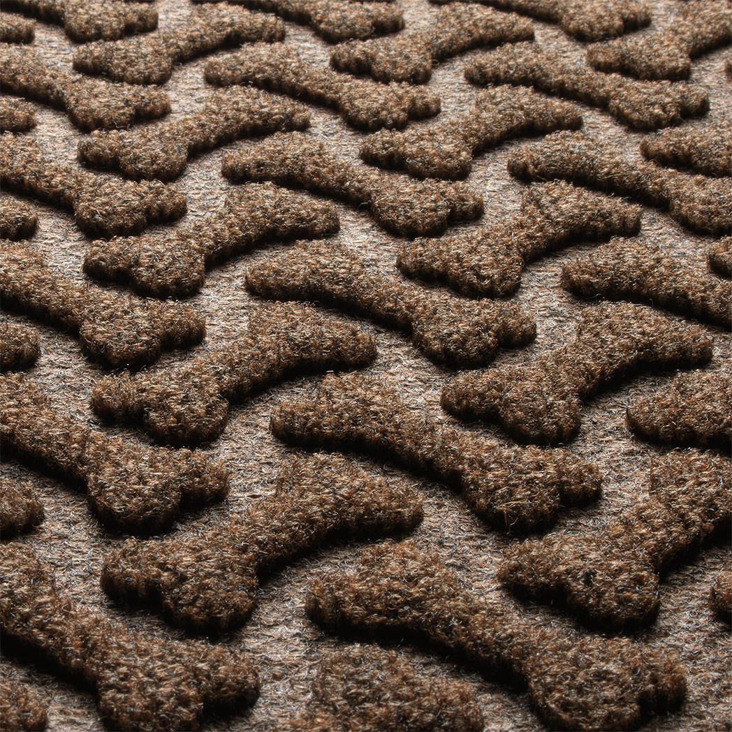 Zoomed in view of Dog Bone's surface made of light and dark brown, white, and black fibers.