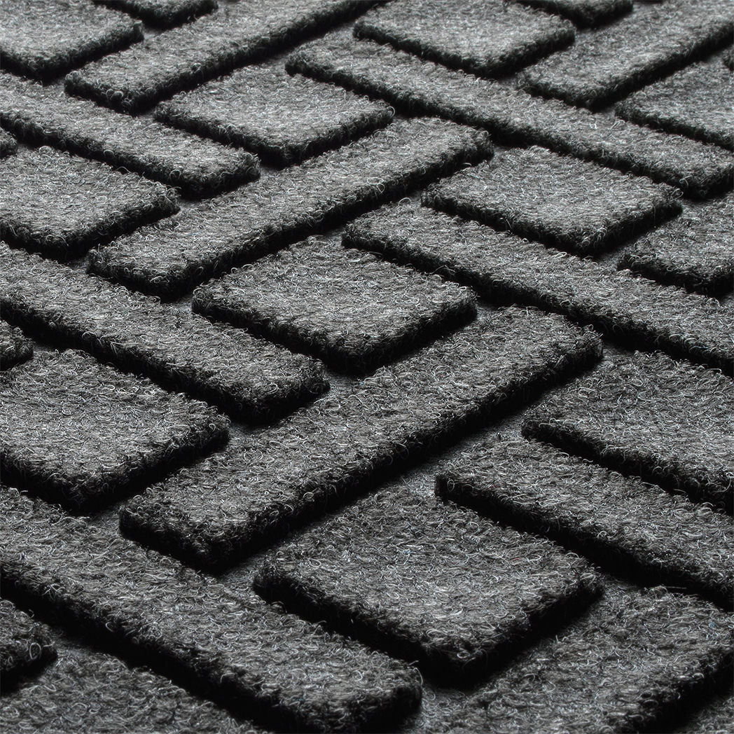 Close-up of WaterHog's Lattice's bi-level surface made of various shades of grey to black, with hints of white fibers.