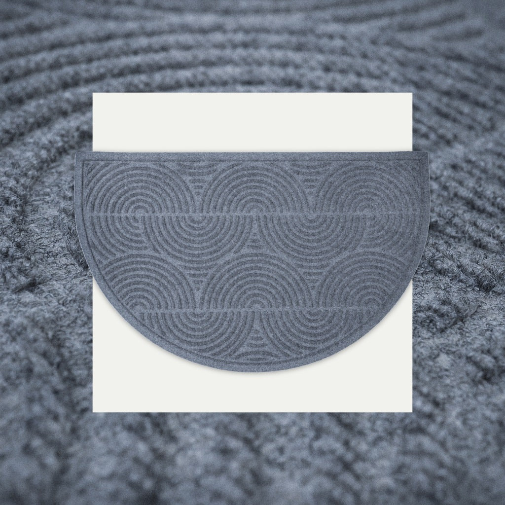An isolated overhead of the unqiue Seabring Half Round doormat stacked on a detailed shot of the fast drying surface design