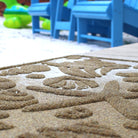 WaterHog Beachcomber outdoor doormat placed next to an outdoor beach setting to catch and trap sand.