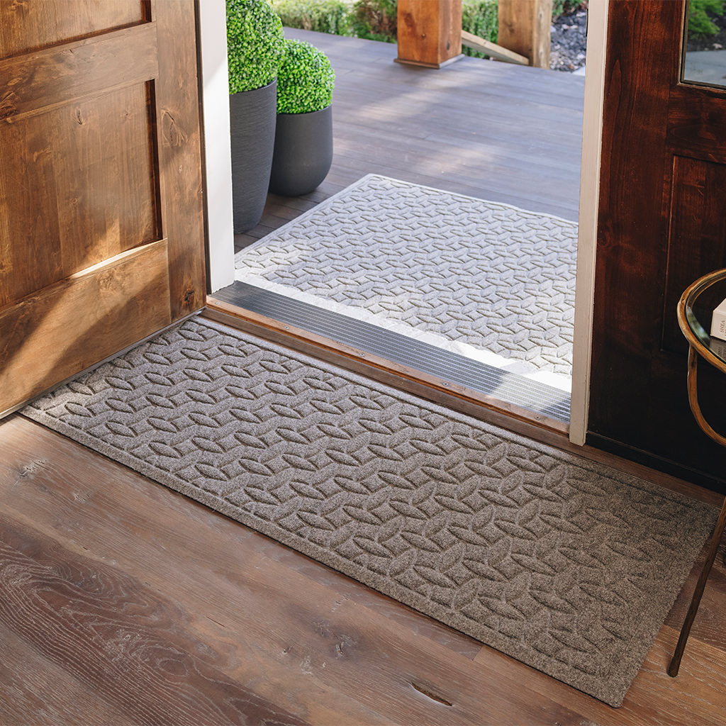 WaterHog Ellipse runner at the door protecting the wooden floors from damage and mess