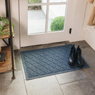 WaterHog Medium doormat in Navy placed at a back door and used as an indoor door rug to catch rain, dirt, and sand.