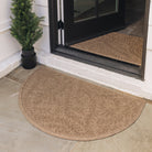 WaterHog Boxwood Outdoor Doormat in a half-circle shaped placed outside on a front porch to scrape and wipe shoes free of moisture, dirt, sand and debris; shown in a light brown color and flanked by a potted green plant.