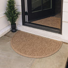 An entrance way displaying two WaterHog Fall Days door mats in tan color with a fallen leaves design. A semi-circular version placed outdoors, with a medium 2x3 rectangular version placed inside.