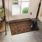 A 2x3 WaterHog Fall Days front door mat in a deep brown color placed inside an entrance way on tile floor.