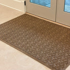 Heavy-duty indoor doormat in front of a double door