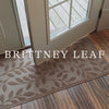 Pair of Brittney Leaf doormat and runner stacked over a runner image at a door with 'BRITTNEY LEAF" typed across