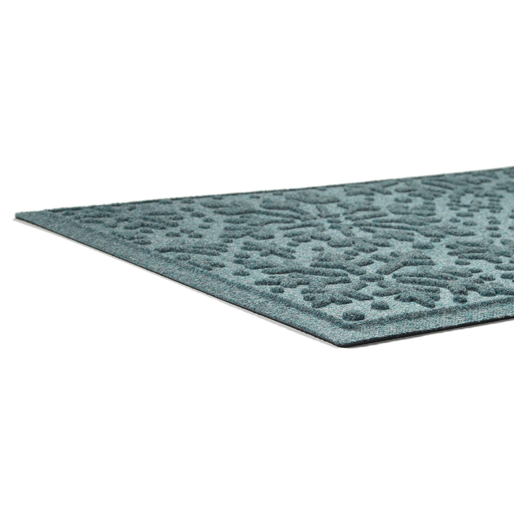 Textured low-profile blue mat on a white background