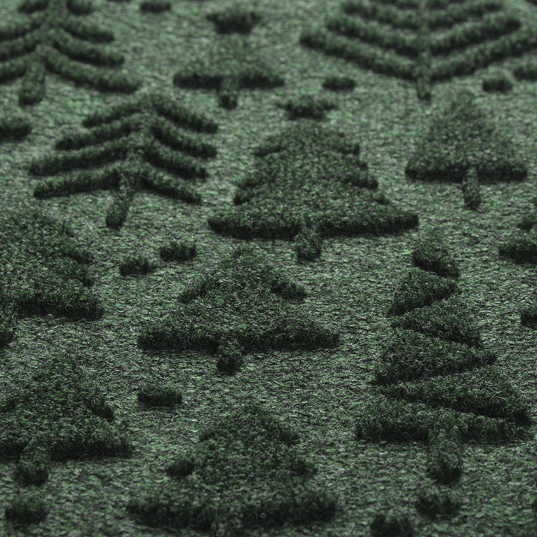 Close up of Tinsel Trail's bi-level, dirt-trapping surface in a deep evergreen made up of green, black, and grey fibers