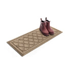 Angled WaterHog 2x3 boot tray mat with a pair of pink rubber boots on the durable, water-resistant surface.