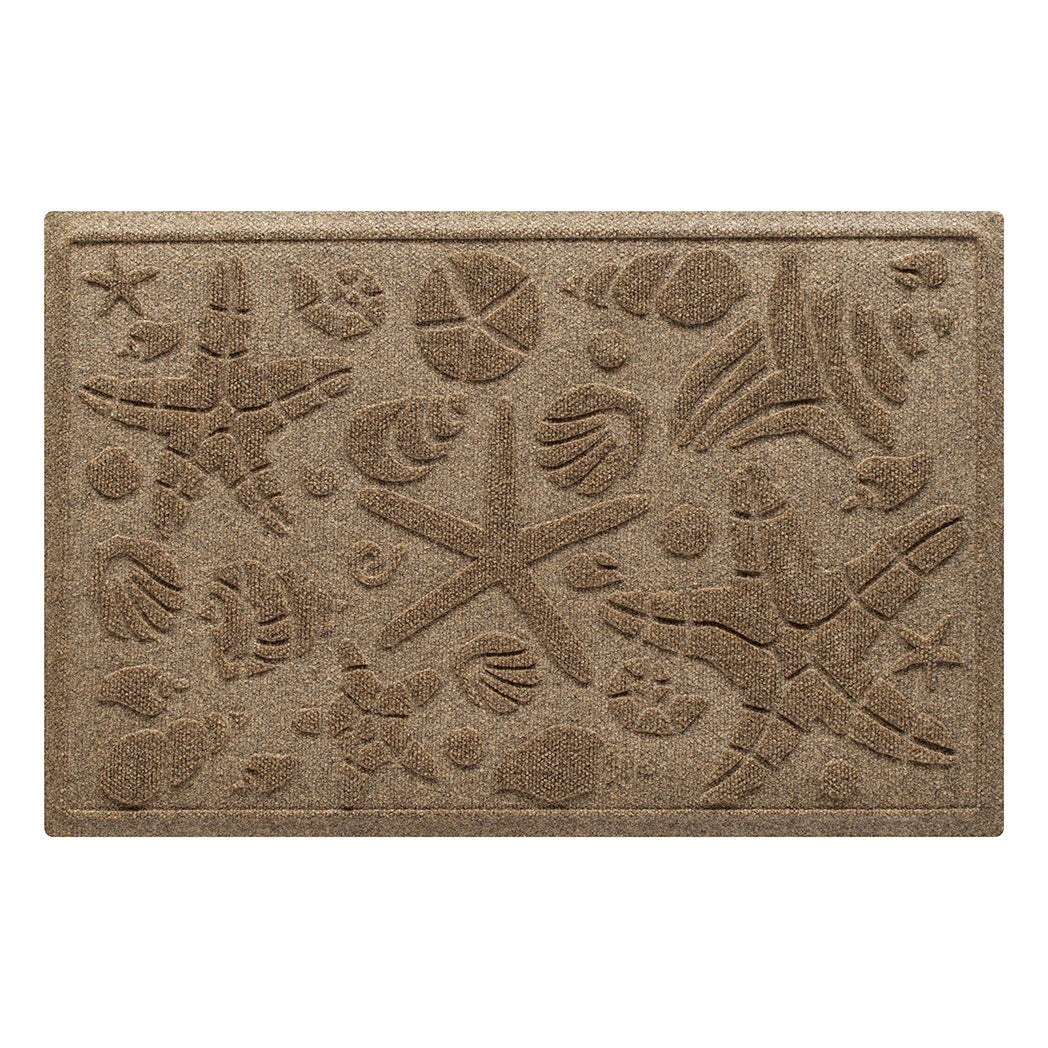 Isolated image of a nautical themed WaterHog Beachcomber medium size indoor/outdoor door mat that features a  unique pattern of sea shells and starfish. Shown in light brown color.