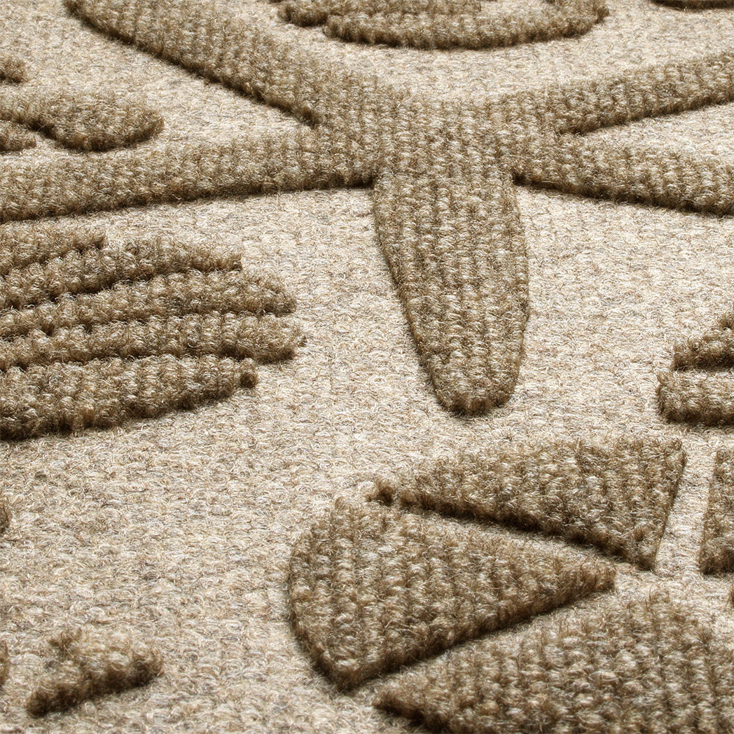 Detailed closeup of WaterHog Beachcomber doormat that features durable PET fibers that are effective and capturing moisture, sand, and debris. Shown in light brown camel color.