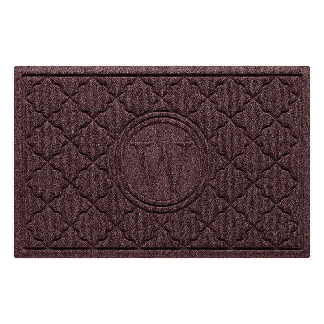 Isolated image of a medium size outdoor WaterHog Bombay Monogrammed Doormat that features a classic repeating geometric pattern with an encircled letter placed in the center; shown in a deep red color.