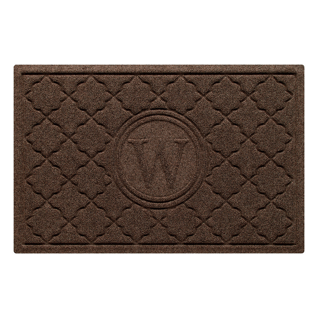 Isolated image of a medium all-weather WaterHog Bombay Monogrammed Outdoor Doormat that features a classic repeating geometric pattern with an encircled letter placed in the center; shown in a dark brown color.