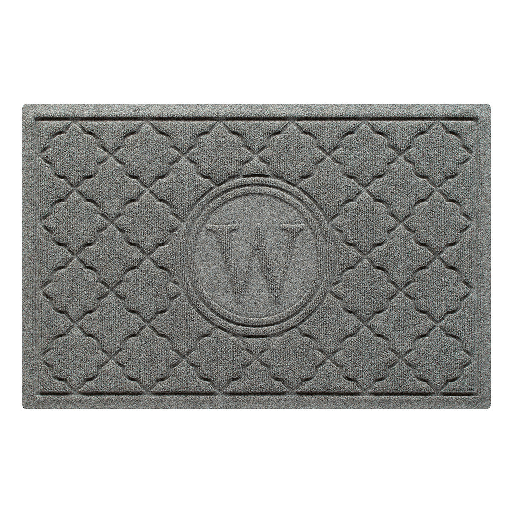 Isolated image of a WaterHog Bombay Monogrammed Outdoor Doormat that features a classic repeating geometric pattern with an encircled letter placed in the center; shown in a medium grey color.