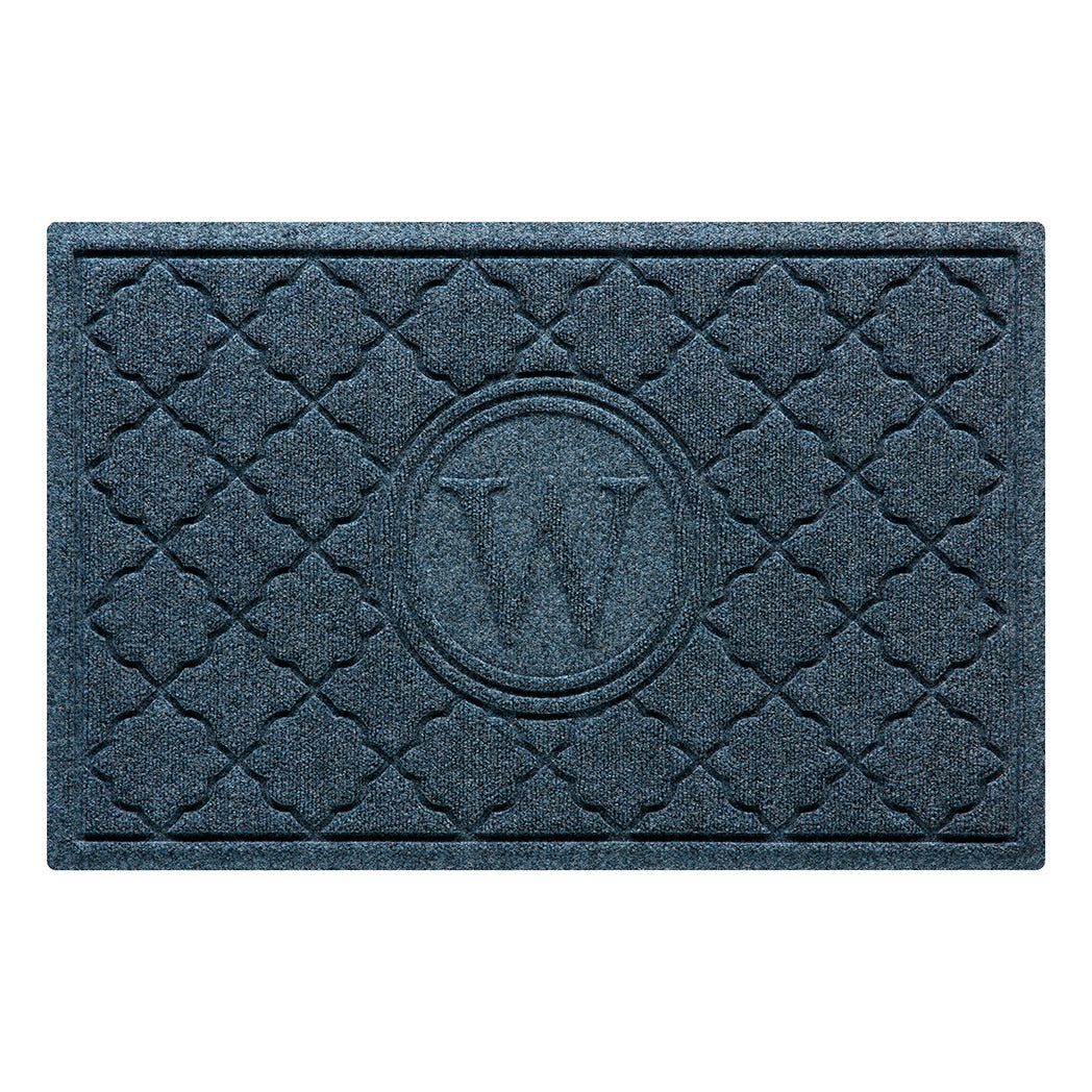 Isolated image of a WaterHog Bombay Monogrammed Outdoor Doormat that features a classic repeating geometric pattern with an encircled letter placed in the center; shown in a navy color.