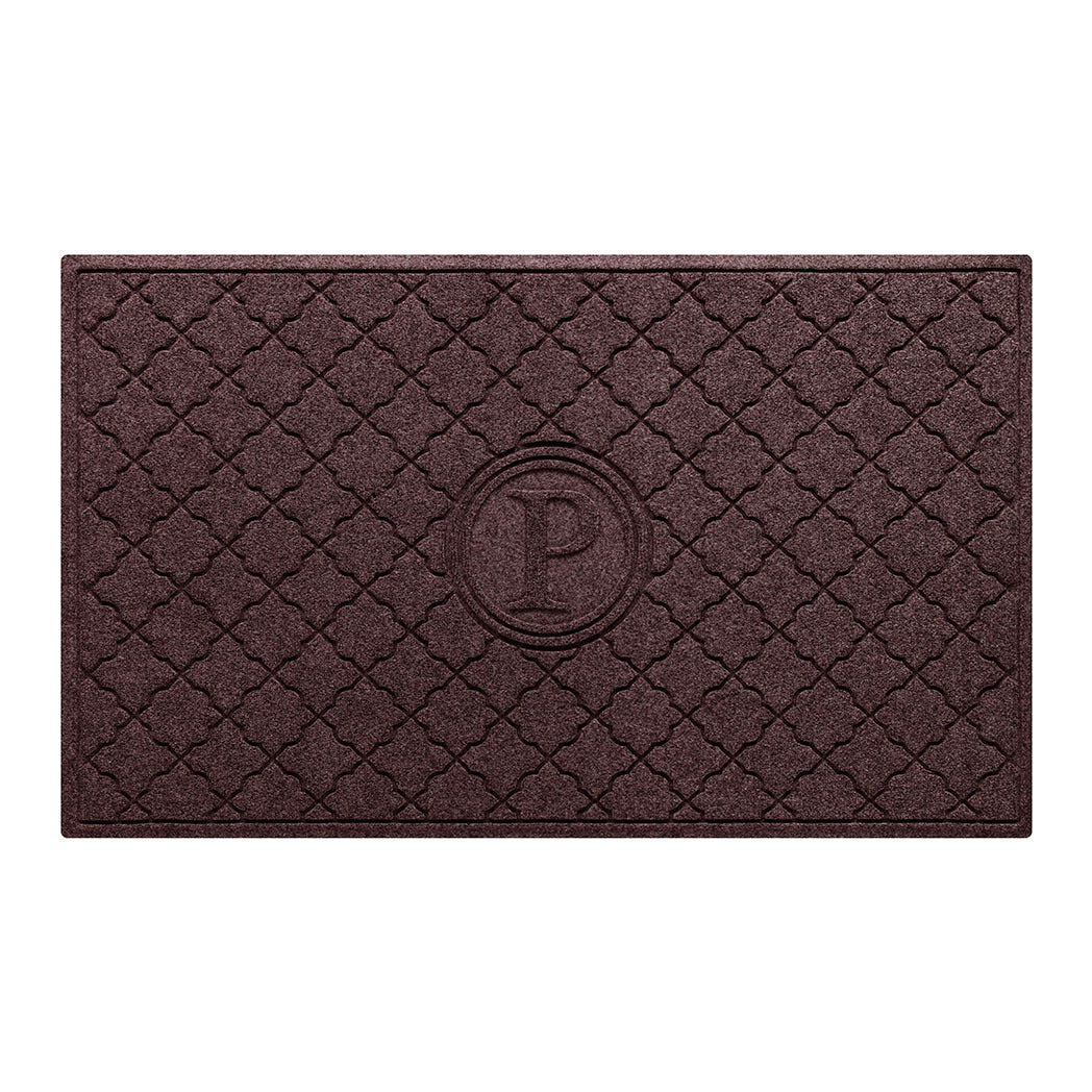 Isolated image of a large outdoor WaterHog Bombay Monogrammed Doormat that features a classic repeating geometric pattern with an encircled letter placed in the center; shown in a deep red color.